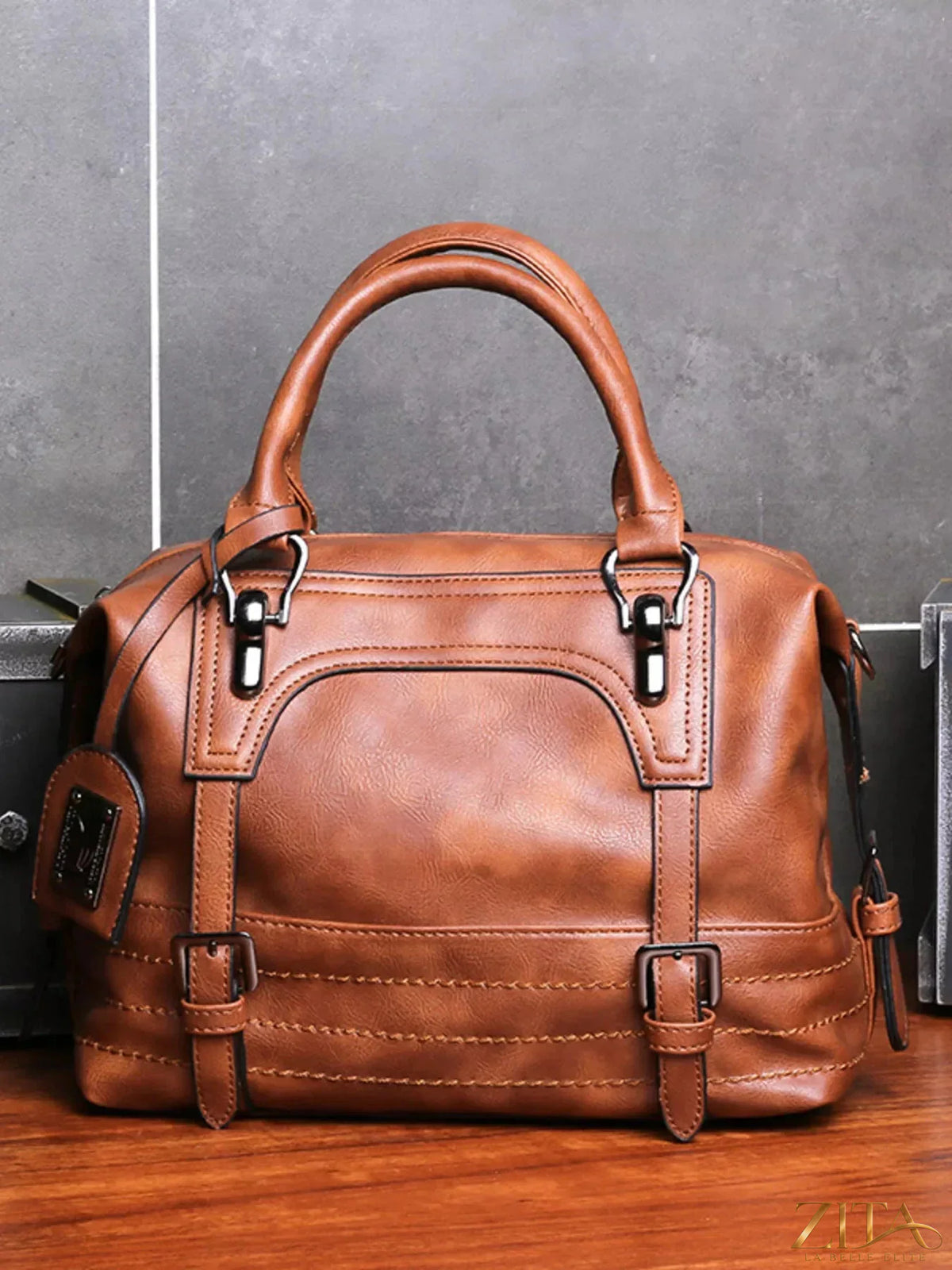 Vintage style Zita La Belle Elite handbag featuring buckle decor, leather finish, and elegant design for classic fashion.