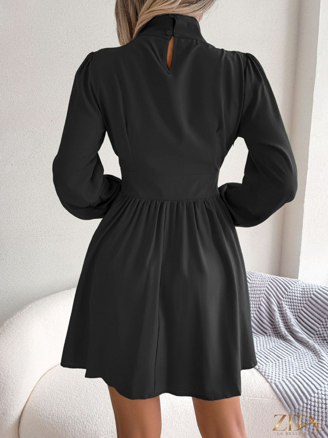 Cutout turtleneck A-line mini dress by Trendsi, featuring a stylish fit with a high neckline and cutout details, displayed on a mannequin.