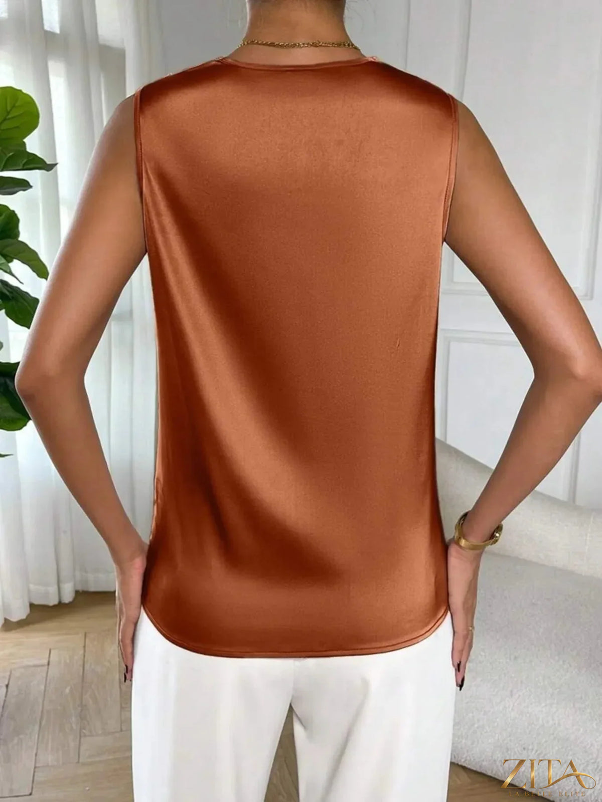 Satin cowl neck sleeveless blouse by Zita La Belle Elite, showcasing smooth fabric and elegant drape on a neutral background.