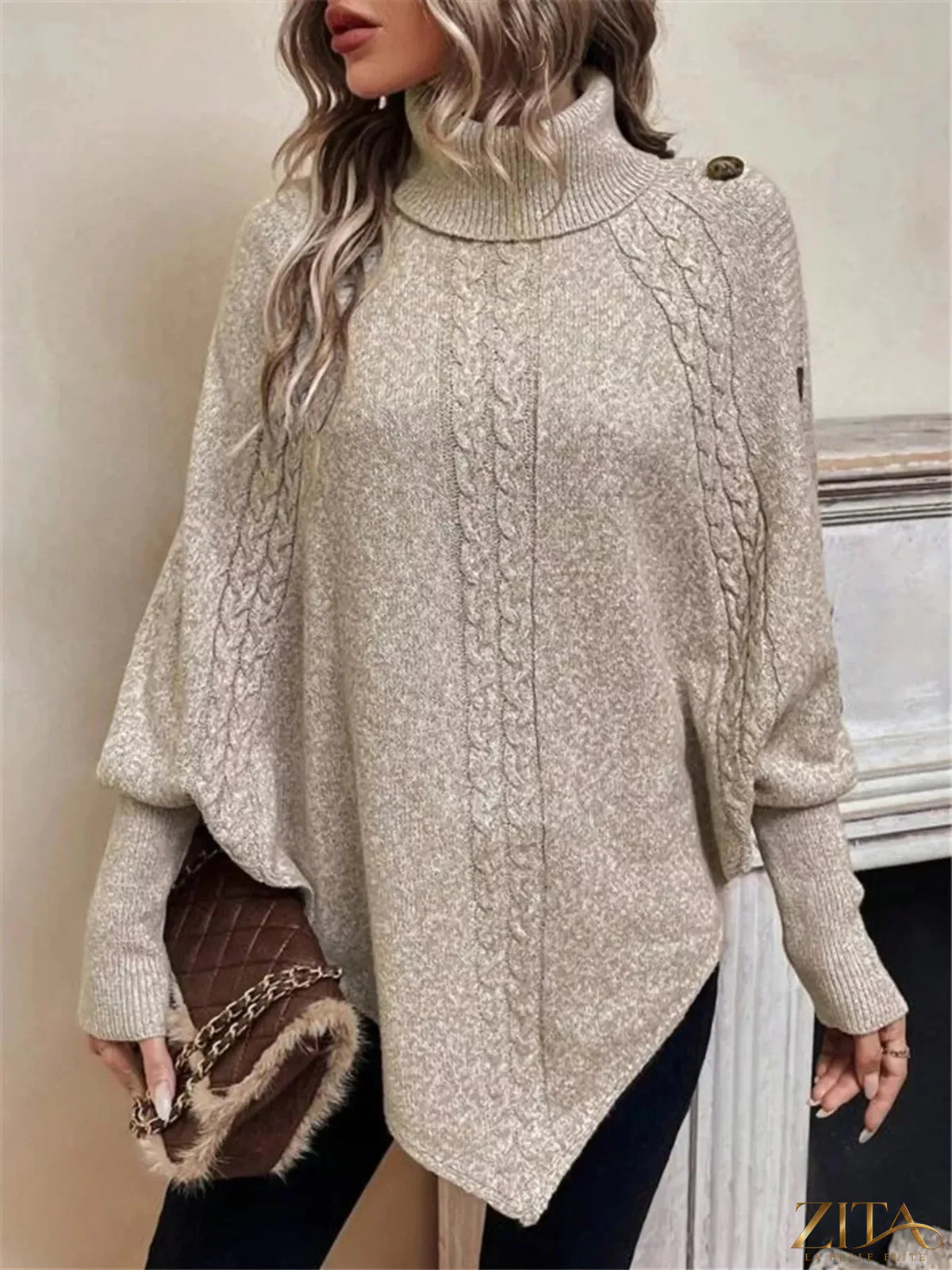 Cable knit turtleneck cape sweater by Trendsi, featuring a cozy, textured design with a high neckline and flowing cape style.