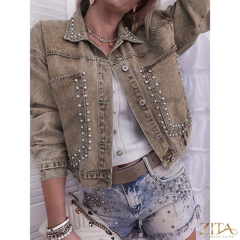 Women’s studded denim jacket by Zita La Belle Elite, showing close-up of distressed denim with silver stud embellishments.