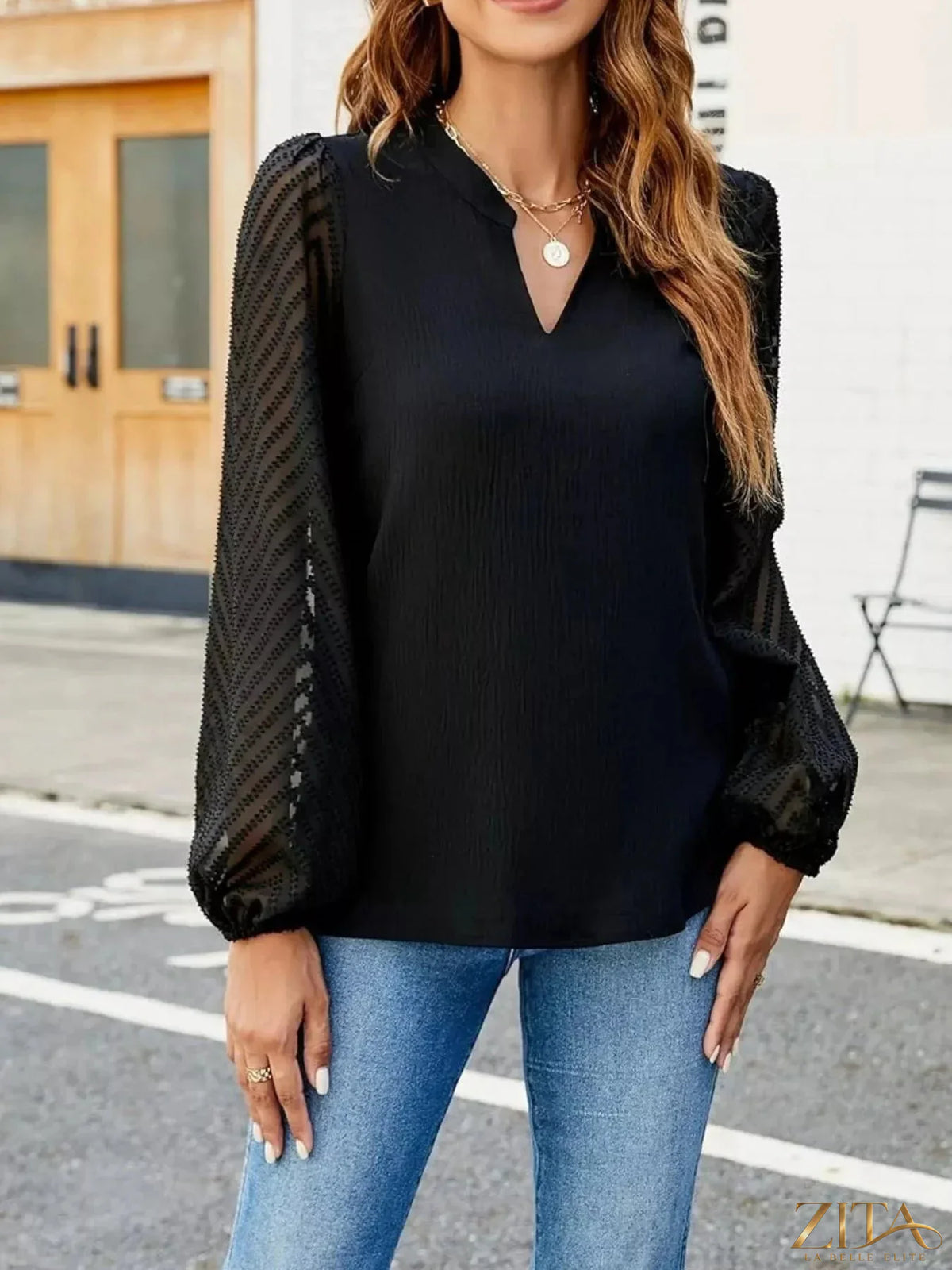Zita La Belle Elite notched balloon sleeve blouse featuring a stylish collar and feminine design, shown in a close-up image.