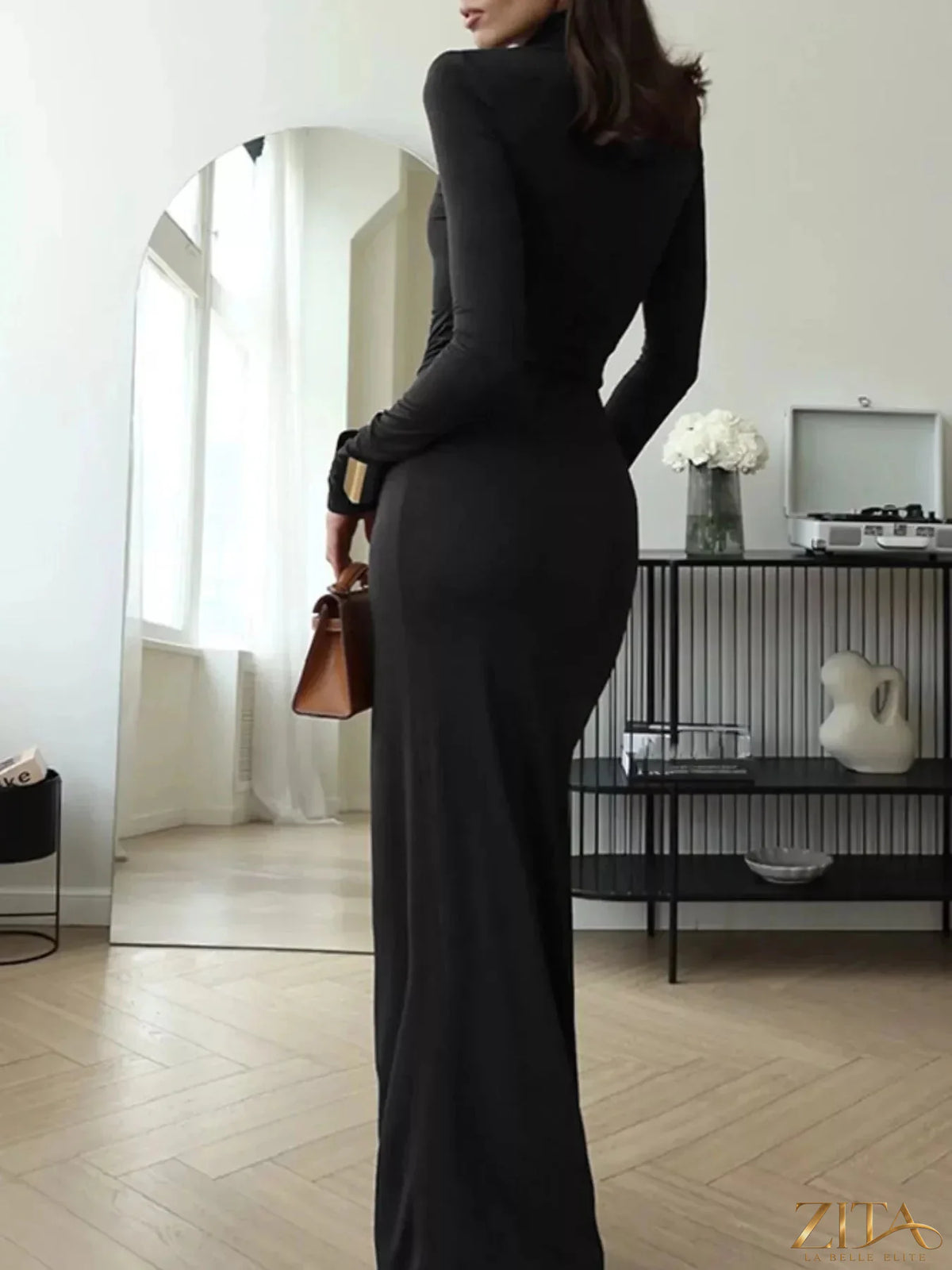 Black turtleneck long sleeve slit maxi dress by Trendsi, featuring a fitted bodice and flowing hem for elegant style.