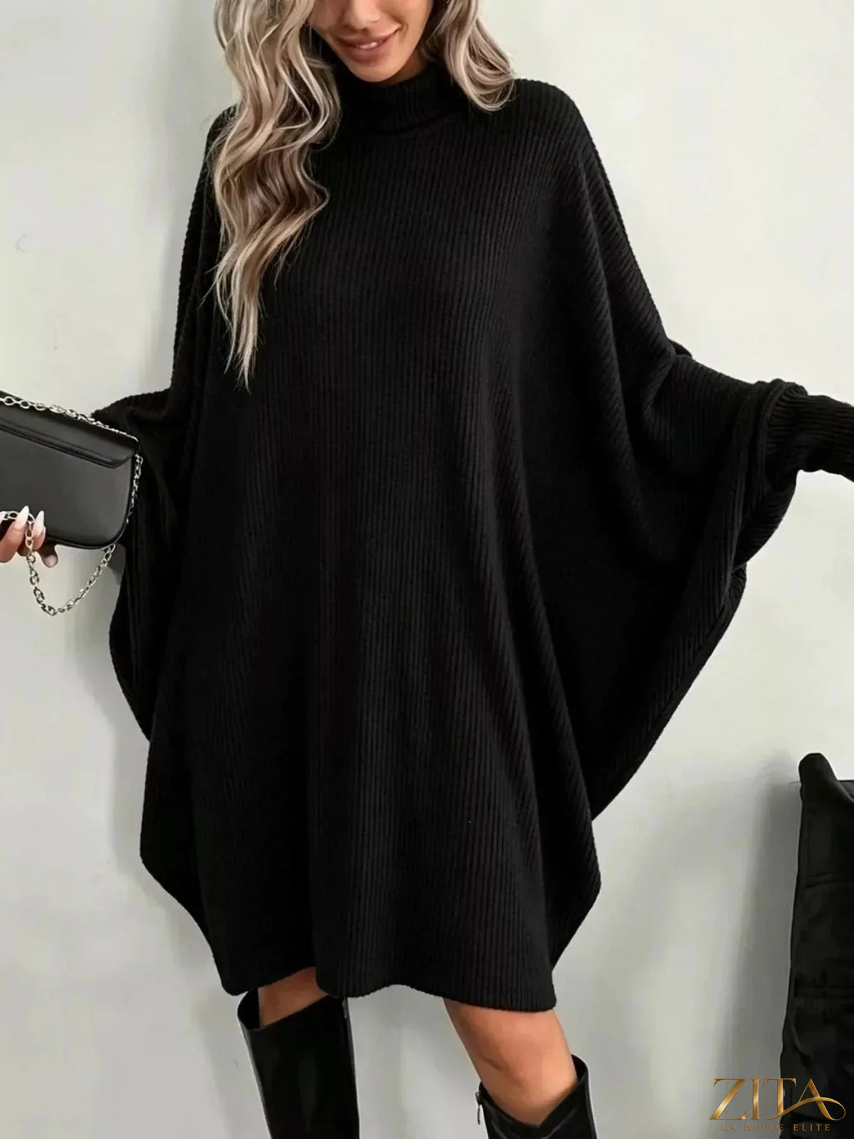 Zita La Belle Elite oversized batwing sleeve ribbed knit turtleneck dress displayed on a model, showcasing its relaxed fit and textured fabric.