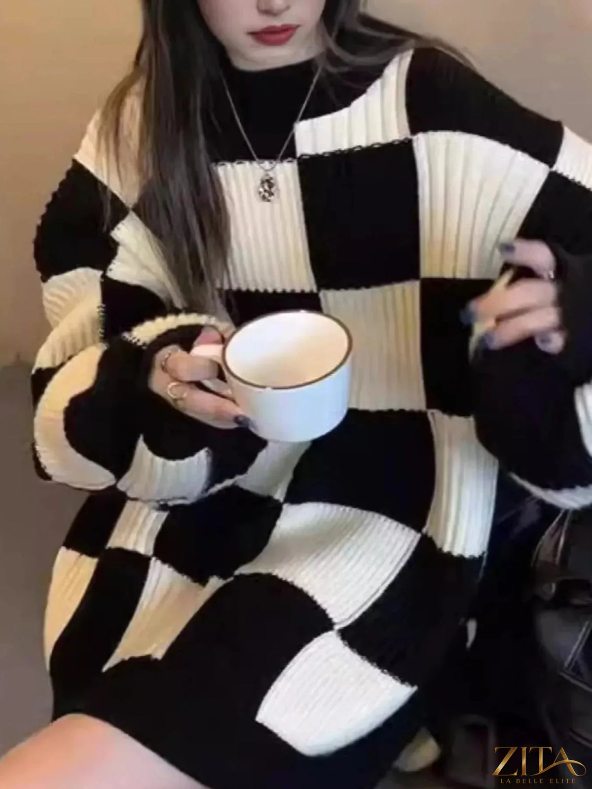 Zita La Belle Elite oversized sweater with black and white checkerboard pattern, soft knit fabric, and relaxed fit.