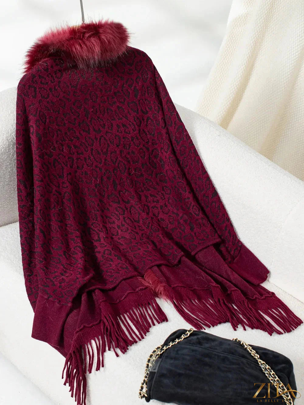 Leopard print fringe open front long sleeve poncho by Trendsi, featuring a stylish animal print design and flowing fabric.