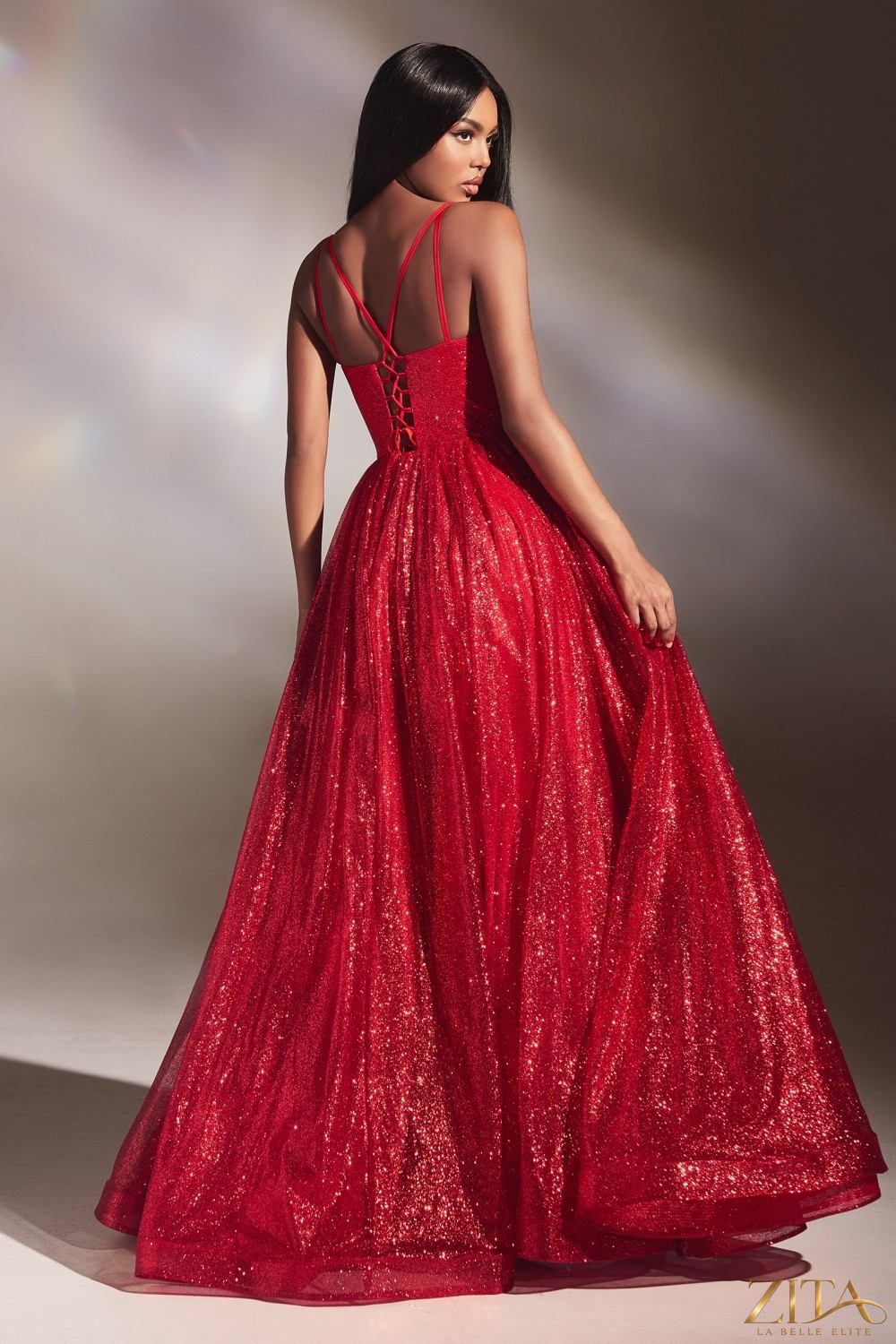 Red floor length A-line glitter ball gown by Zita La Belle Elite, showcasing elegant fabric and flowing silhouette.