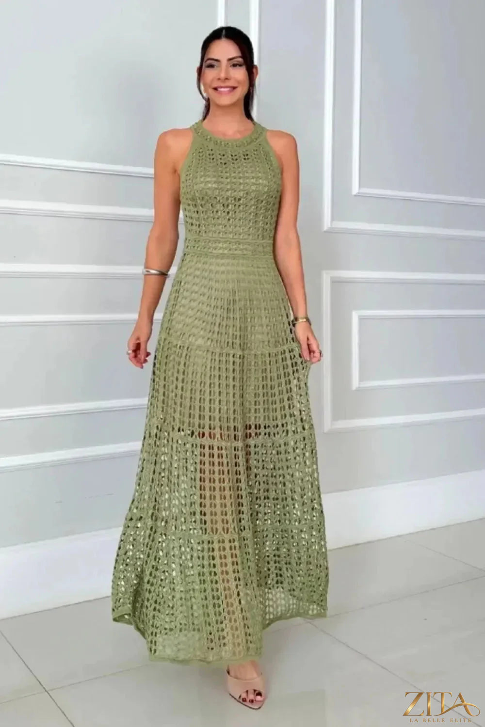 Hollowed-out sleeveless maxi dress by Zita La Belle Elite with a flowing silhouette and cut-out details, perfect for summer wear.