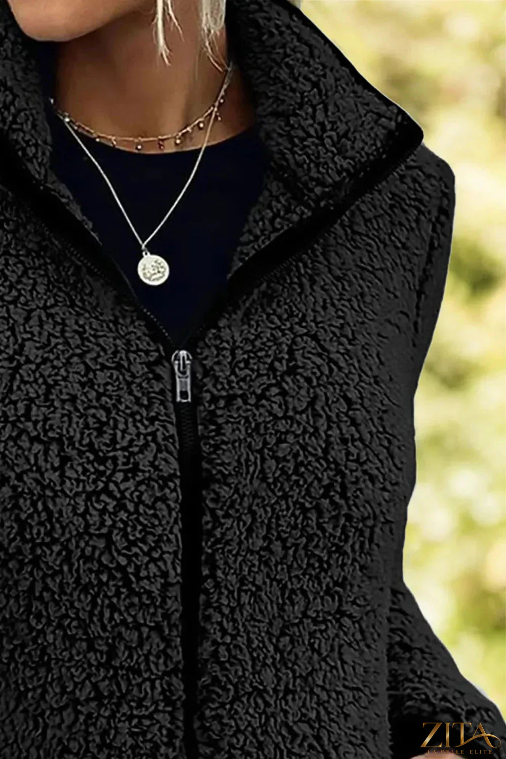 Black pocketed zip-up turtleneck jacket by Trendsi, featuring a fitted style with front pockets and a high collar.