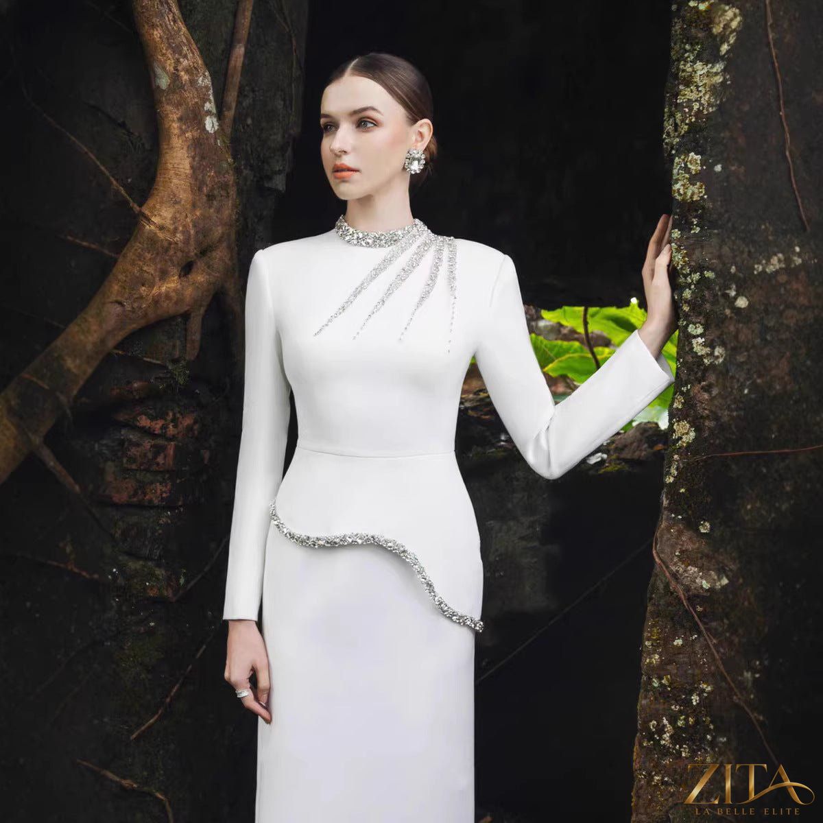 Crystal-embellished evening gown by Zita La Belle Elite, featuring intricate crystal details and elegant flowing fabric.