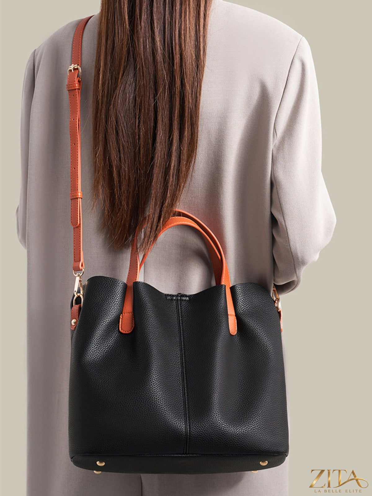 Leather contrast handle handbag by Trendsi featuring a sleek design and stylish handles on a light background.