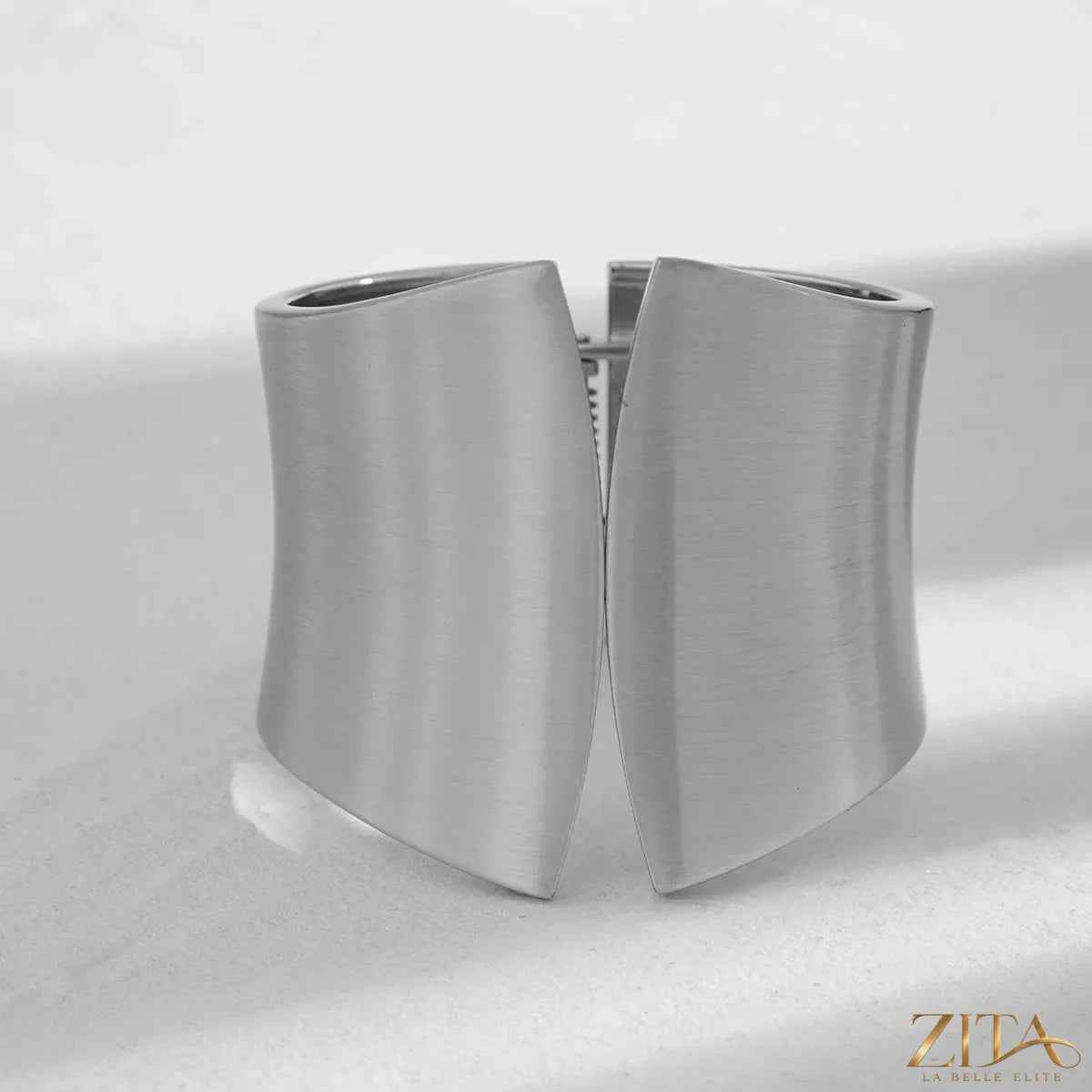 Wide cuff bracelet by Zita La Belle Elite featuring a sleek gold-tone design with smooth, rounded edges.