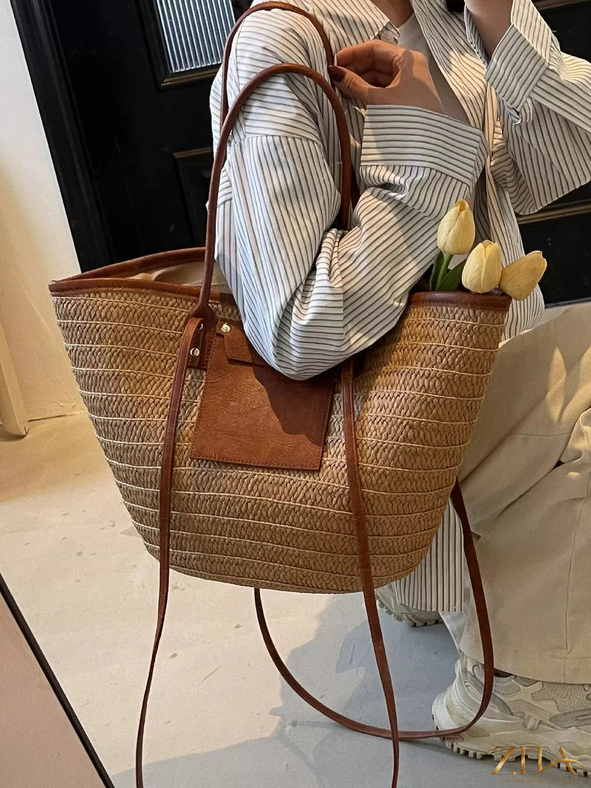Woven straw tote bag by Zita La Belle Elite with sturdy handles and natural woven texture, perfect for casual outings.