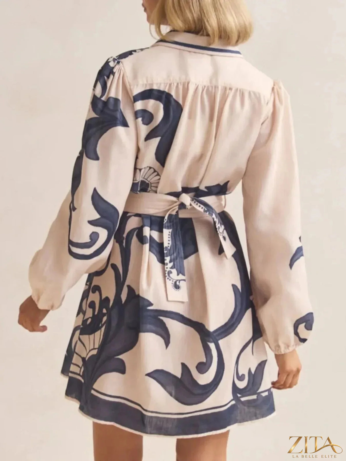 Printed long sleeve shirt dress by Trendsi featuring a stylish design, button-front, and relaxed fit for casual wear.