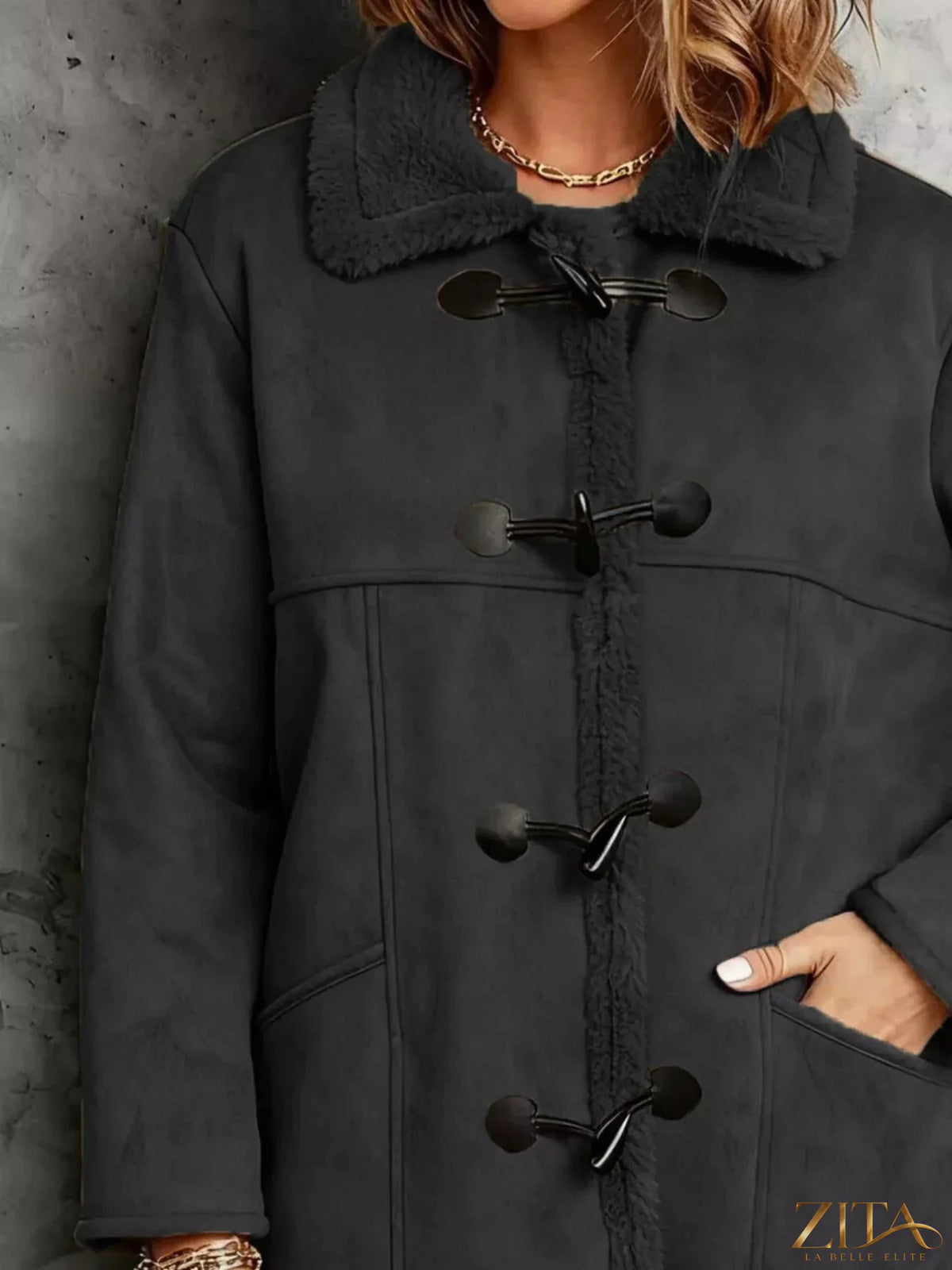 Zita La Belle Elite faux suede sherpa-lined toggle coat displayed on a model, featuring a cozy collar and toggle buttons.