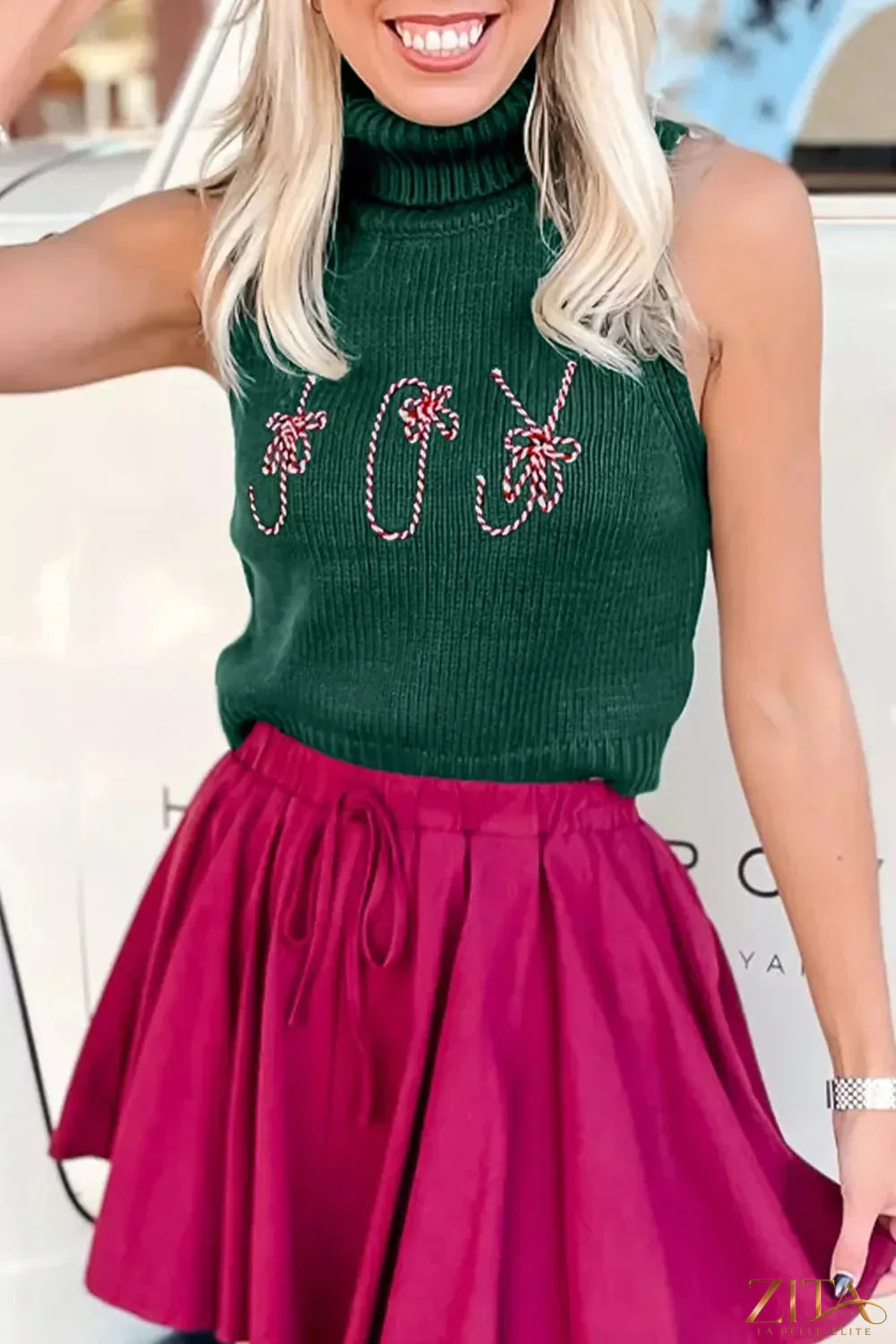 Zita La Belle Elite festive candy cane embroidered turtleneck sweater vest with holiday-themed design and vibrant red and white colors.