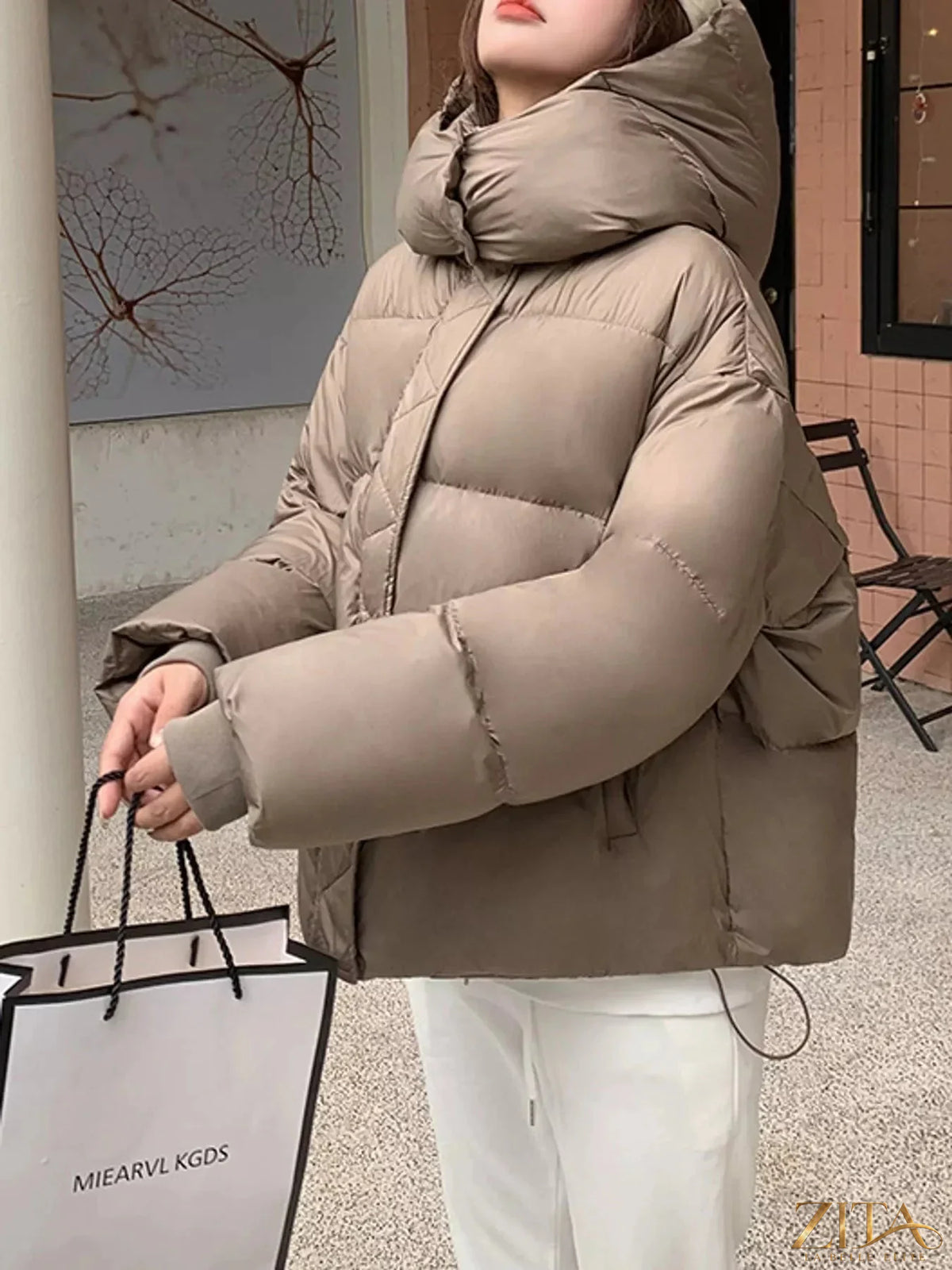 Zita La Belle Elite quilted hooded puffer jacket with padded insulation and front zipper, styled for cold weather.