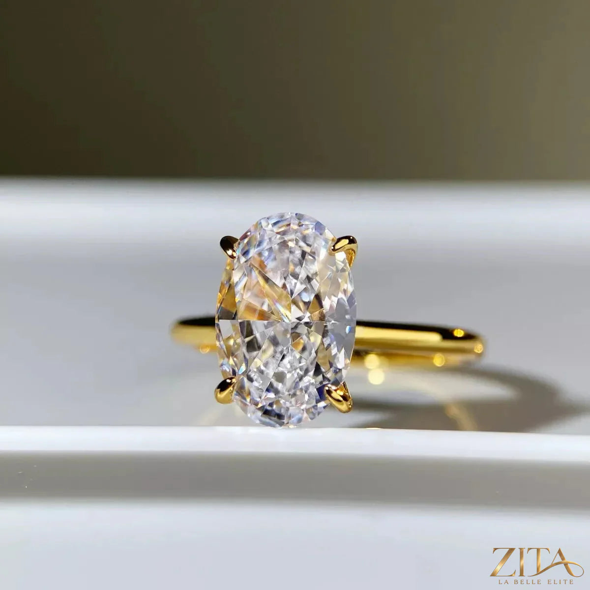 18K gold-plated zircon ring by Zita La Belle Elite featuring a sparkling zircon stone and elegant design on a white background.