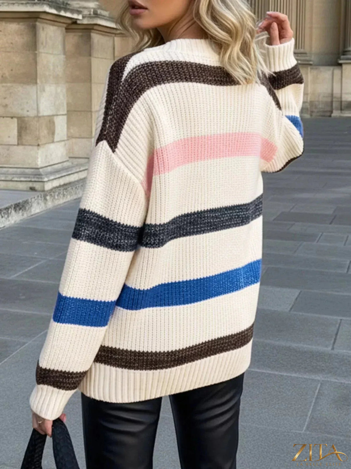Striped V-neck oversized sweater by Trendsi featuring bold horizontal stripes and a relaxed fit, perfect for casual wear.