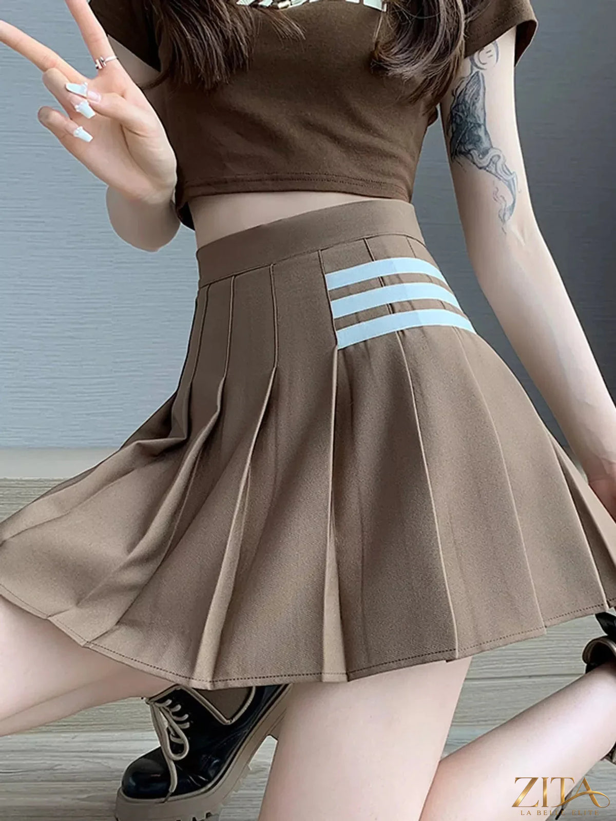 Contrast stripe pleated mini skirt from Trendsi, showcasing its stylish design with bold stripes and a flattering fit.