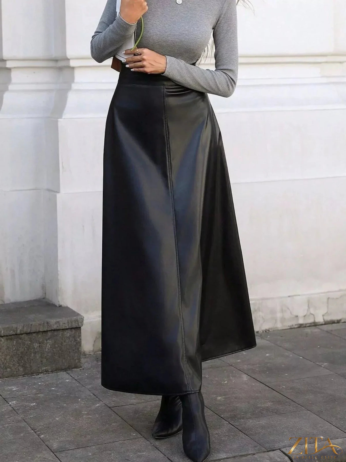 Leather A-Line midi skirt by Trendsi, showcasing smooth leather fabric, high waist design, and flowing silhouette.