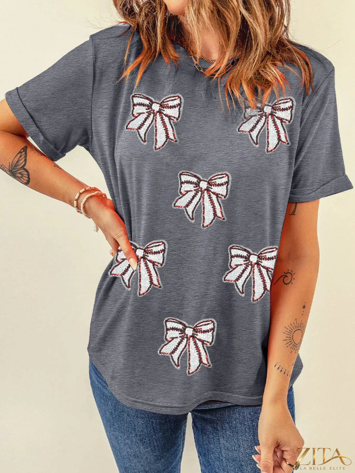 Sequin bow short sleeve T-shirt from Trendsi featuring a shiny sequin bow detail on the front, casual and stylish design.