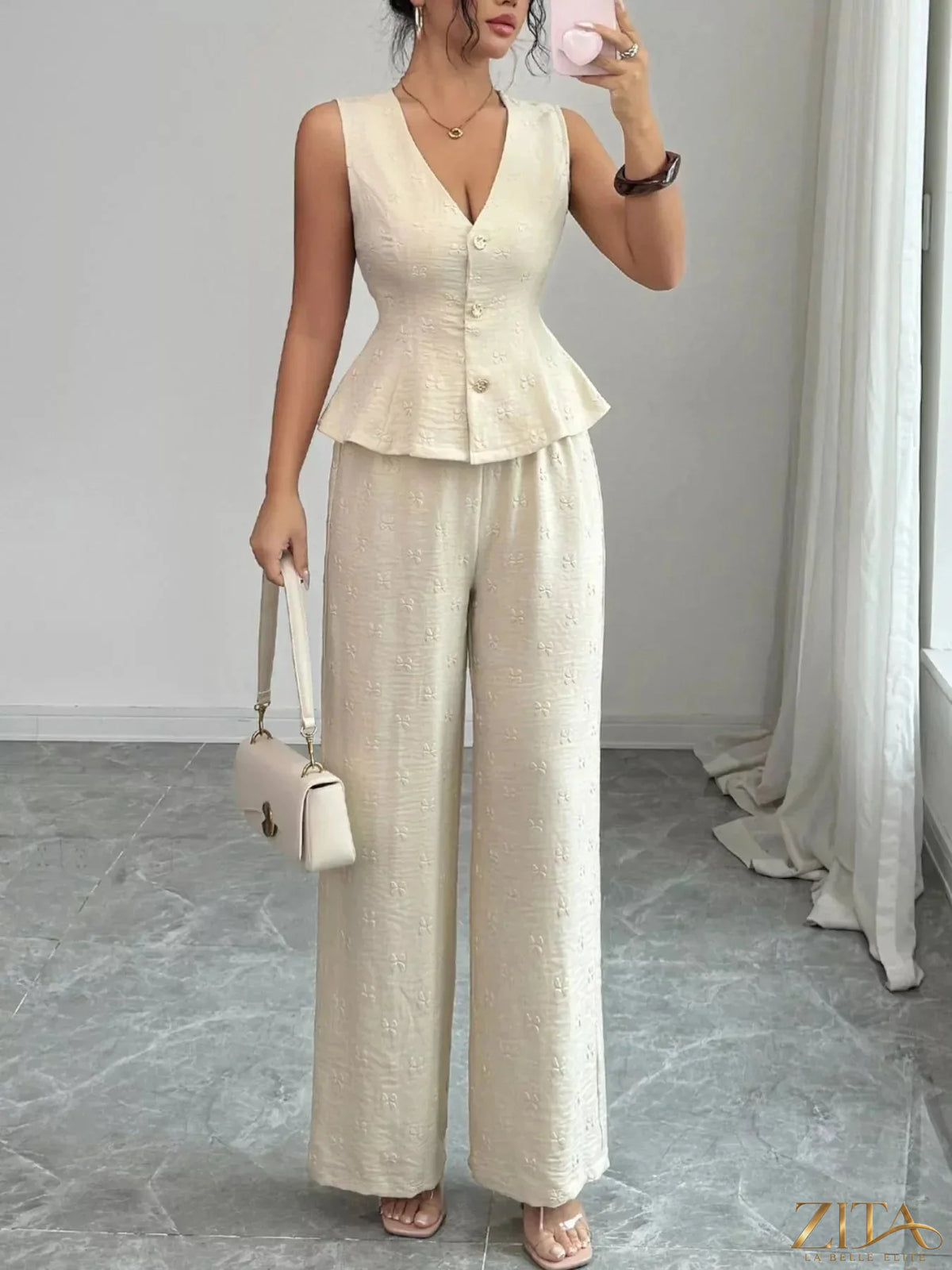 Zita La Belle Elite sleeveless peplum top and wide-leg pants set, stylish and elegant outfit on a model.