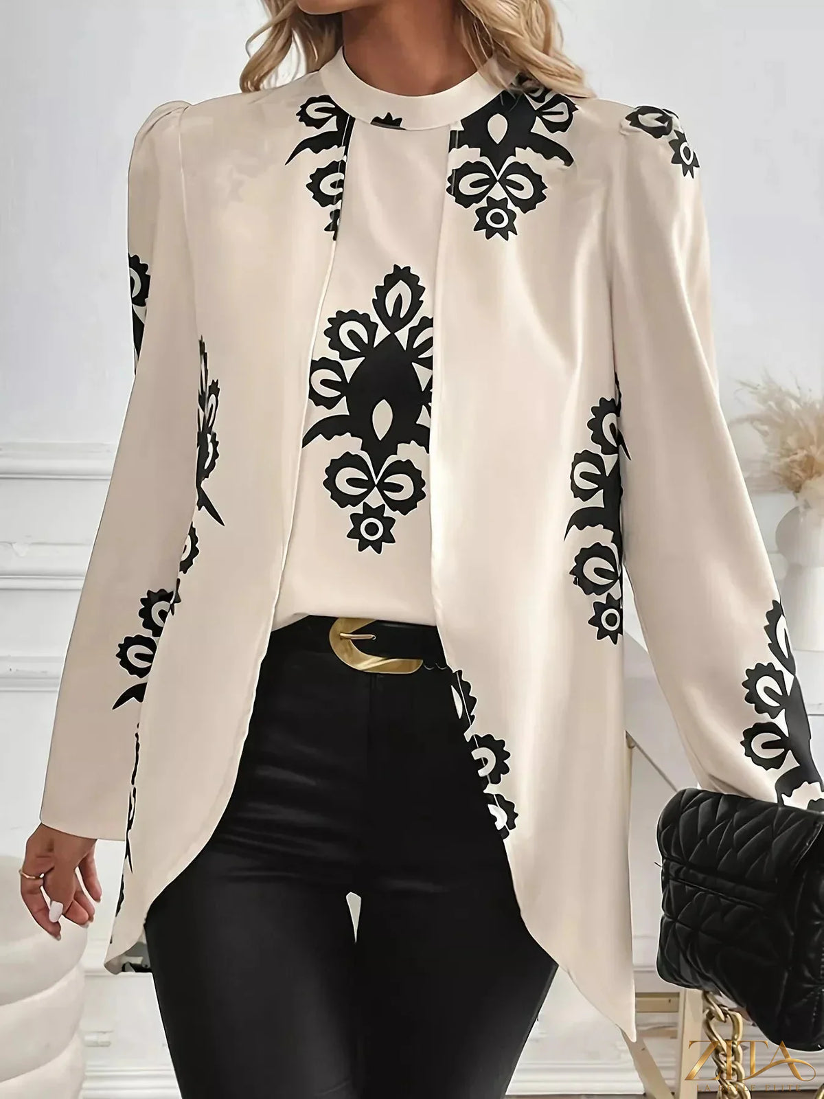 Printed long sleeve blouse by Zita La Belle Elite with floral pattern and lightweight fabric, shown on a hanger.