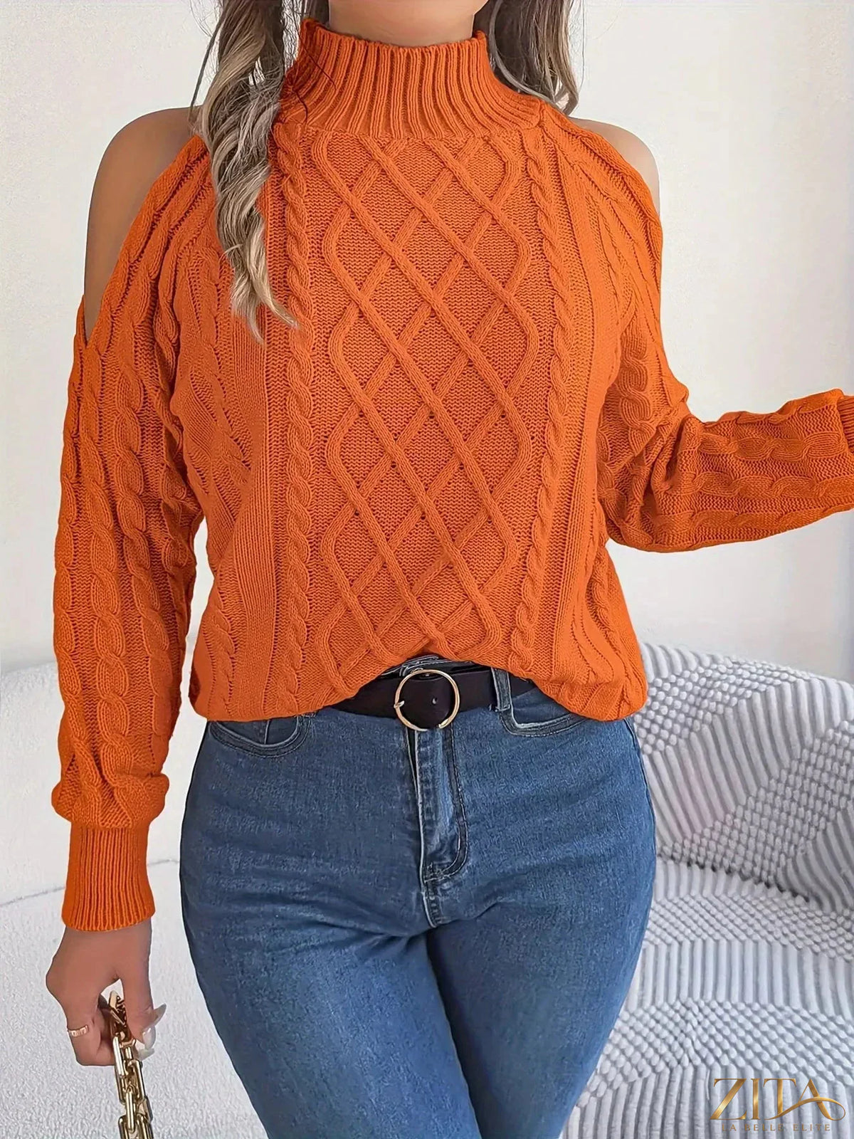 Zita La Belle Elite cold-shoulder cable knit sweater in soft, cozy fabric with open shoulder design and intricate knit pattern.
