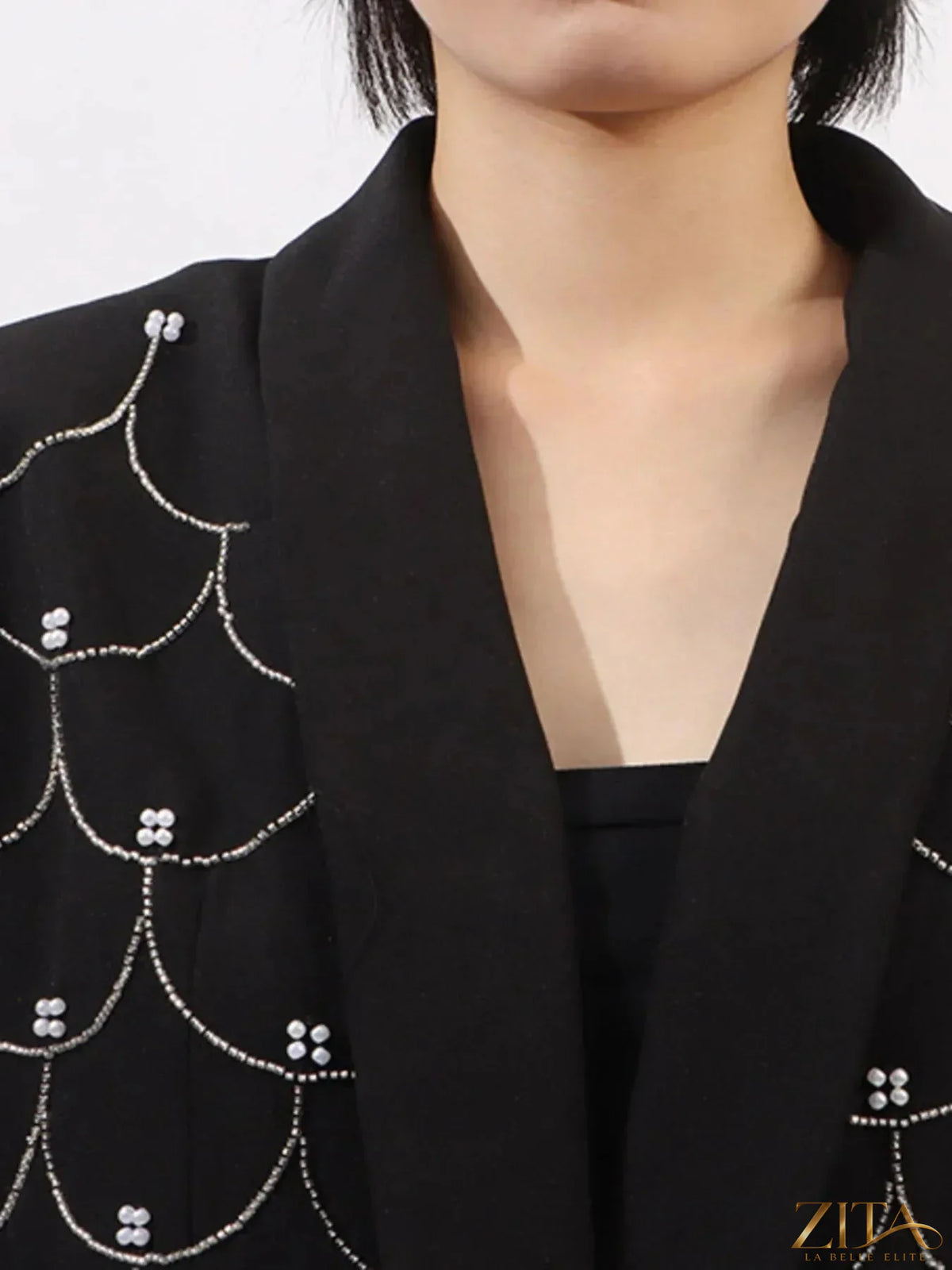 Zita La Belle Elite pearl detail long sleeve blazer showing a tailored black blazer with pearl embellishments on the sleeves and lapels.