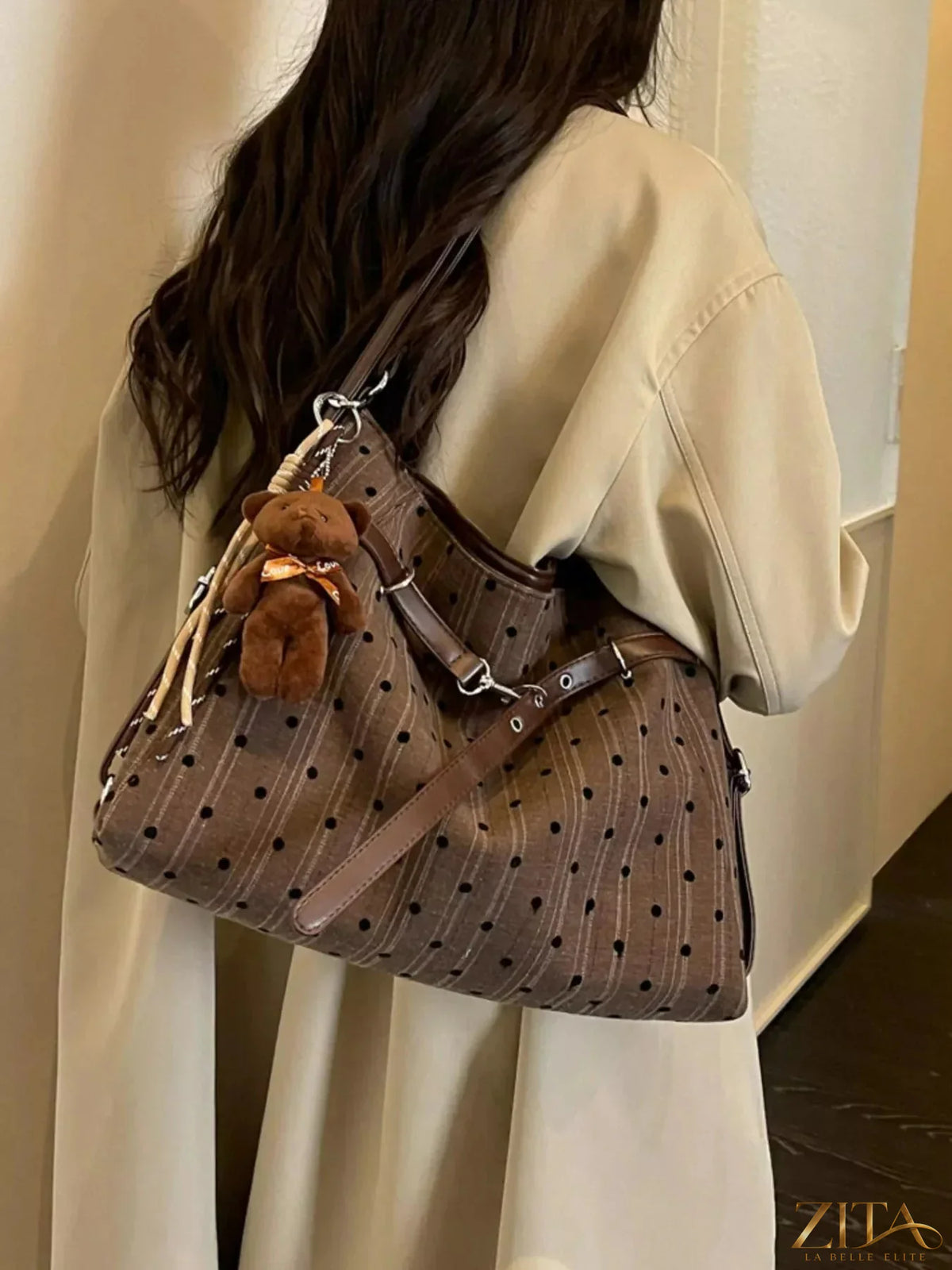 Zita La Belle Elite polka dot shoulder bag with black and white pattern, featuring a sleek strap and compact design.