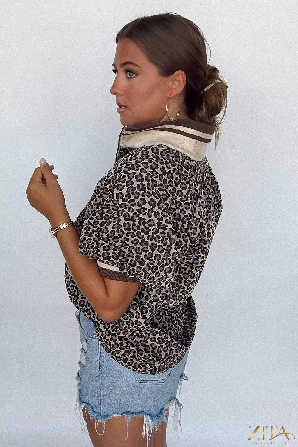 Leopard print half zip blouse by Zita La Belle Elite featuring a stylish collar and fitted design, displayed on a white background.
