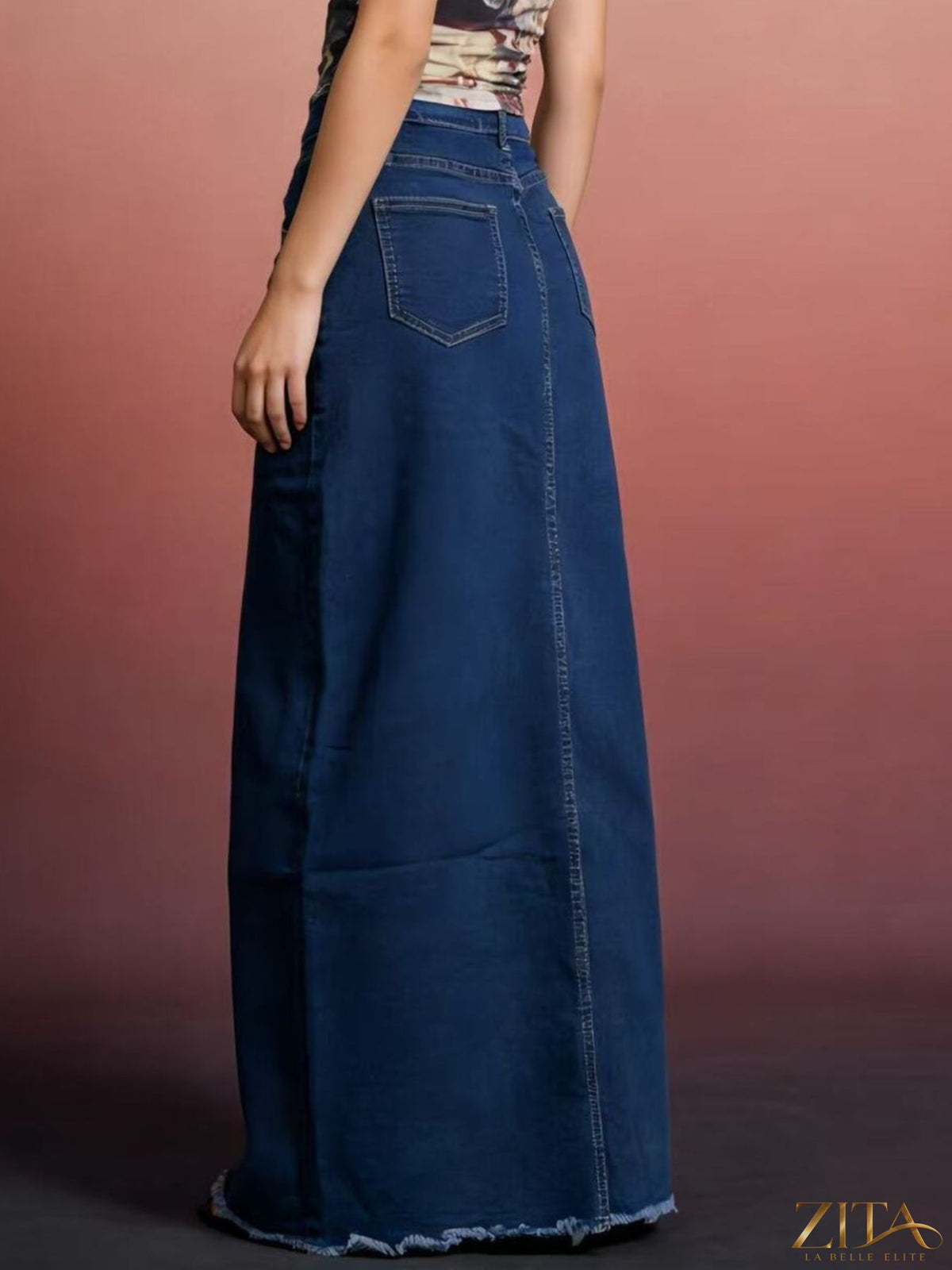Raw hem maxi denim skirt by Zita La Belle Elite featuring a flowing silhouette and distressed detailing.