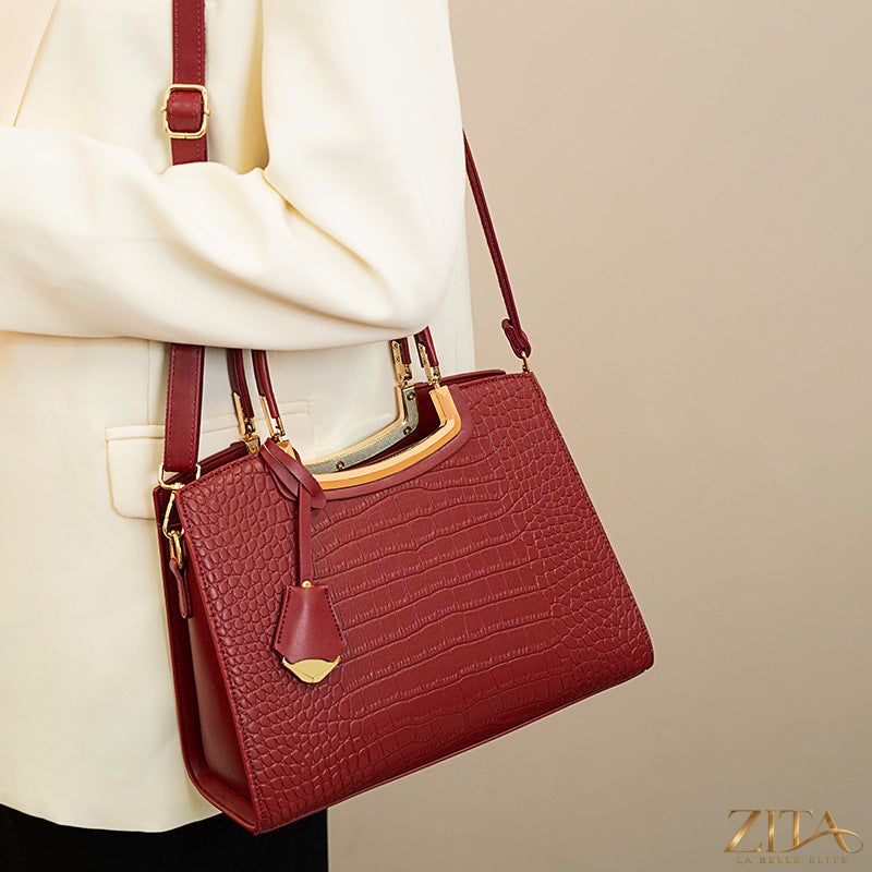 Crocodile embossed leather top handle handbag by Zita La Belle Elite with gold-tone hardware and structured design.