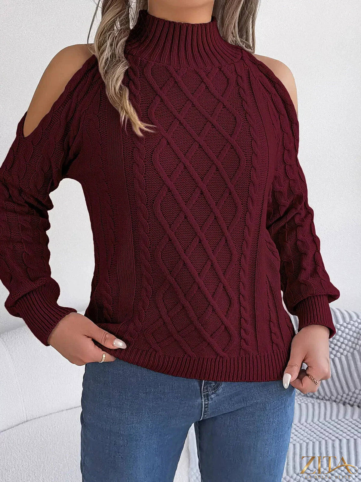 Zita La Belle Elite cold-shoulder cable knit sweater in soft fabric with open shoulder design and ribbed cuffs.