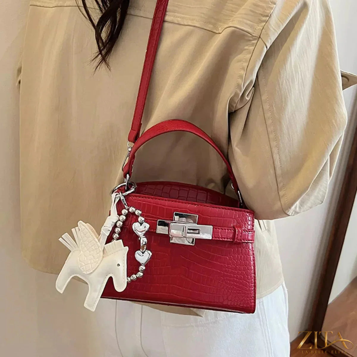 Crocodile-embossed top-handle handbag by Zita La Belle Elite with gold-tone hardware and structured design.
