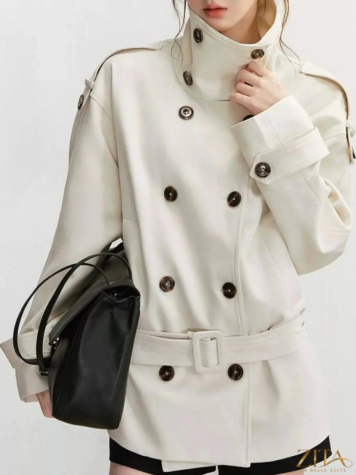 Zita La Belle Elite double-breasted turtleneck trench coat with belt and classic design, shown on a woman in a stylish outdoor setting.