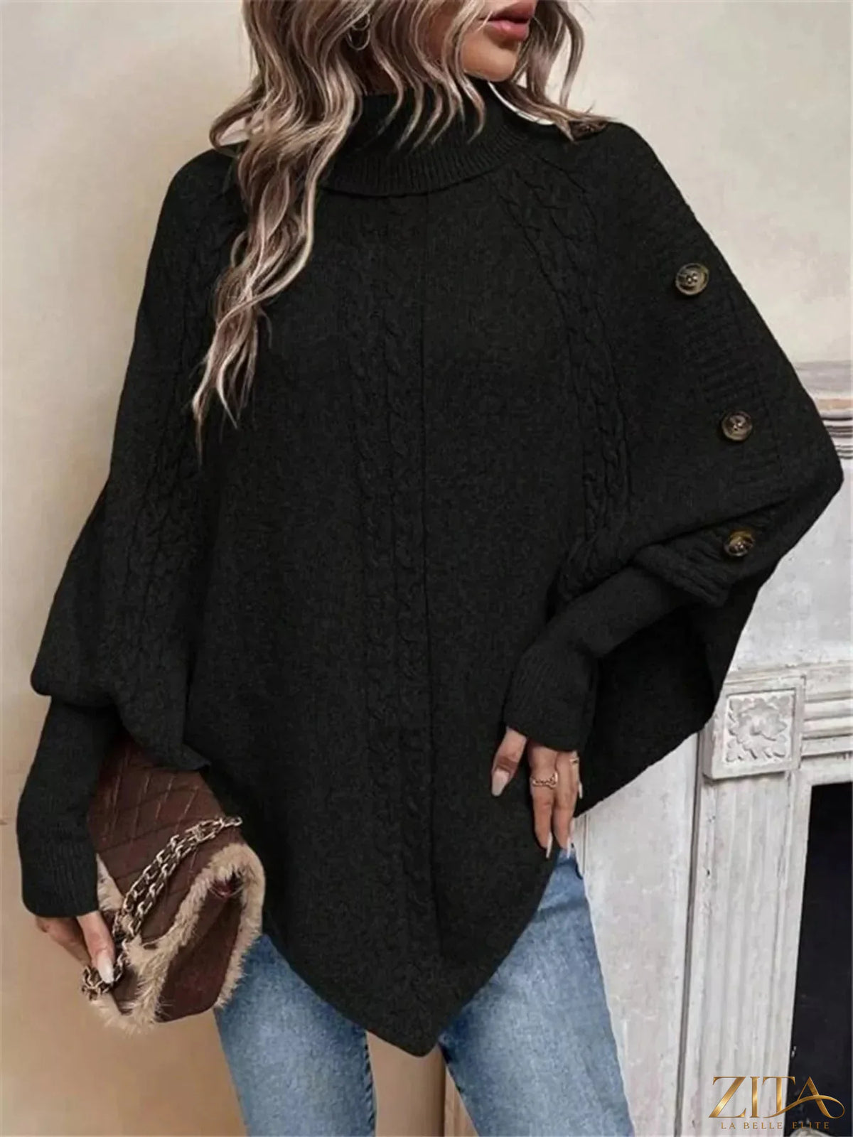 Cable knit turtleneck cape sweater by Trendsi, featuring a cozy, textured design with a high neckline and draped silhouette.