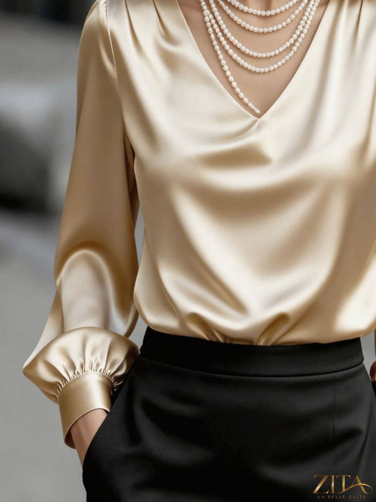 Zita La Belle Elite satin V-neck long sleeve blouse with elegant drape and smooth fabric in a close-up of the stylish top.