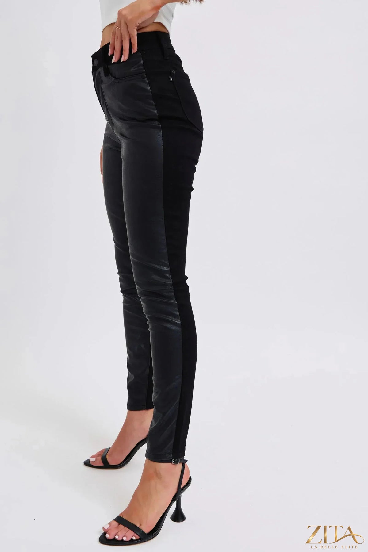 Plus size Judy Blue HW faux leather skinny pants from Zita La Belle Elite, shown in a close-up of the sleek black leather fabric.