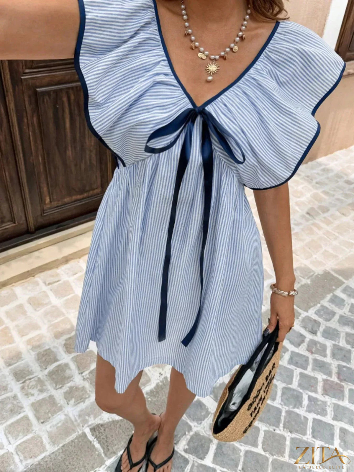 Striped ruffle sleeve mini dress by Trendsi featuring a fitted silhouette and playful ruffle accents on the sleeves.