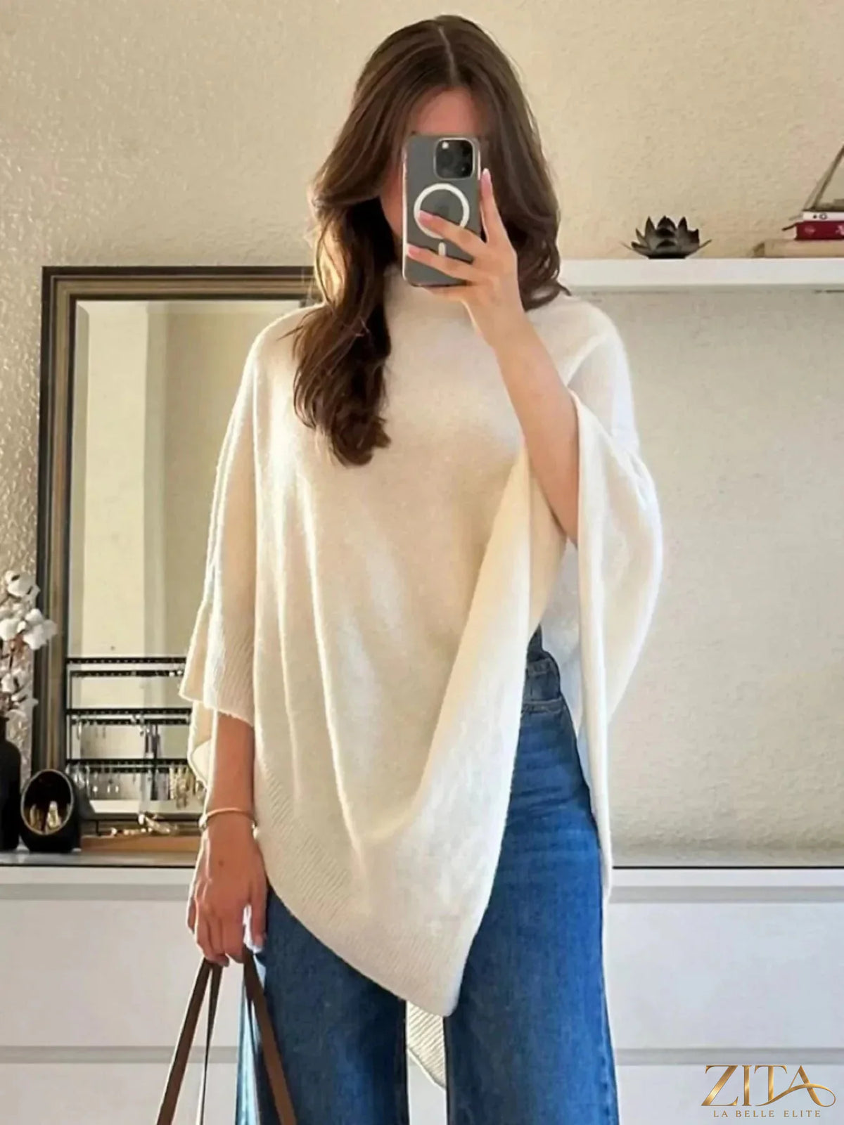 Loose knit turtleneck sweater poncho by Trendsi featuring a cozy, oversized design in soft, textured fabric.