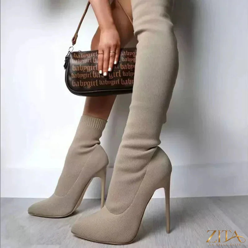 Point toe stiletto boots by Trendsi featuring sleek black leather, high heels, and a stylish pointed toe design.