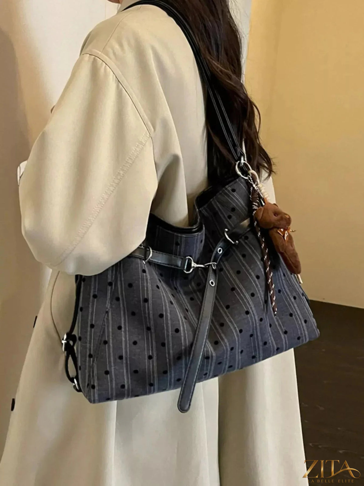 Zita La Belle Elite polka dot shoulder bag with adjustable strap and top zipper closure, black and white polka dot pattern.