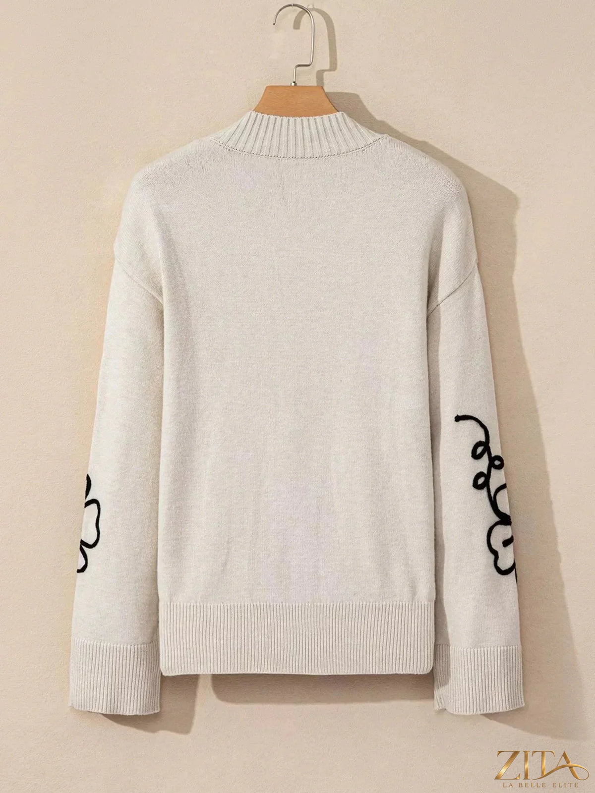 Zita La Belle Elite Flower Stitching Mock Neck Sweater featuring floral embroidery and a ribbed mock neck design.