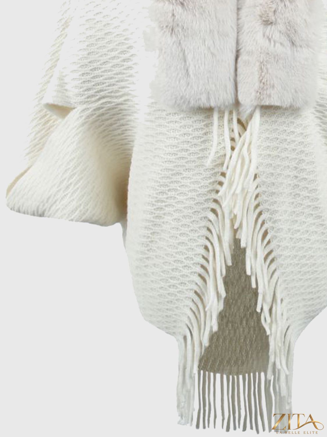 Open front fringe hem poncho with flowy fabric and fringe detailing, perfect for layering and stylish fall or winter looks.