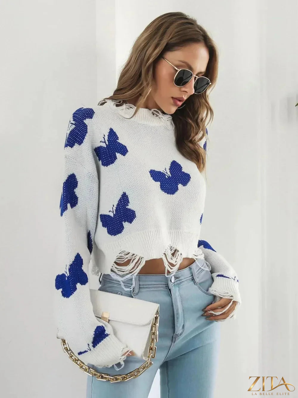 Distressed butterfly design cropped sweater by Zita La Belle Elite, featuring a fashionable, edgy look with a soft knit texture.