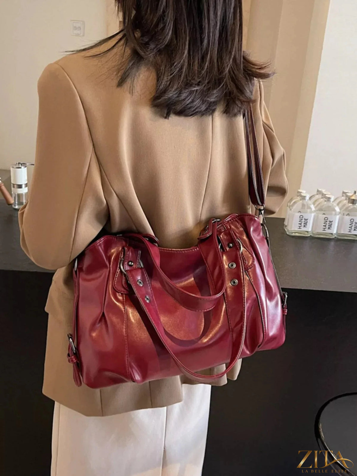 Vintage style leather handbag by Trendsi featuring a classic design, sturdy handle, and elegant leather finish.