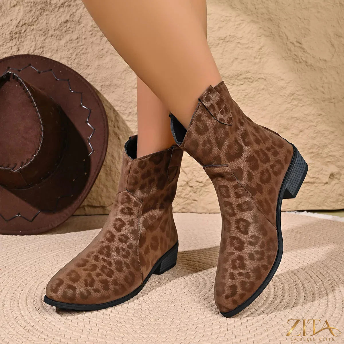 Leopard print Western ankle boots from Trendsi featuring a pointed toe and chunky heel, stylish animal print footwear.