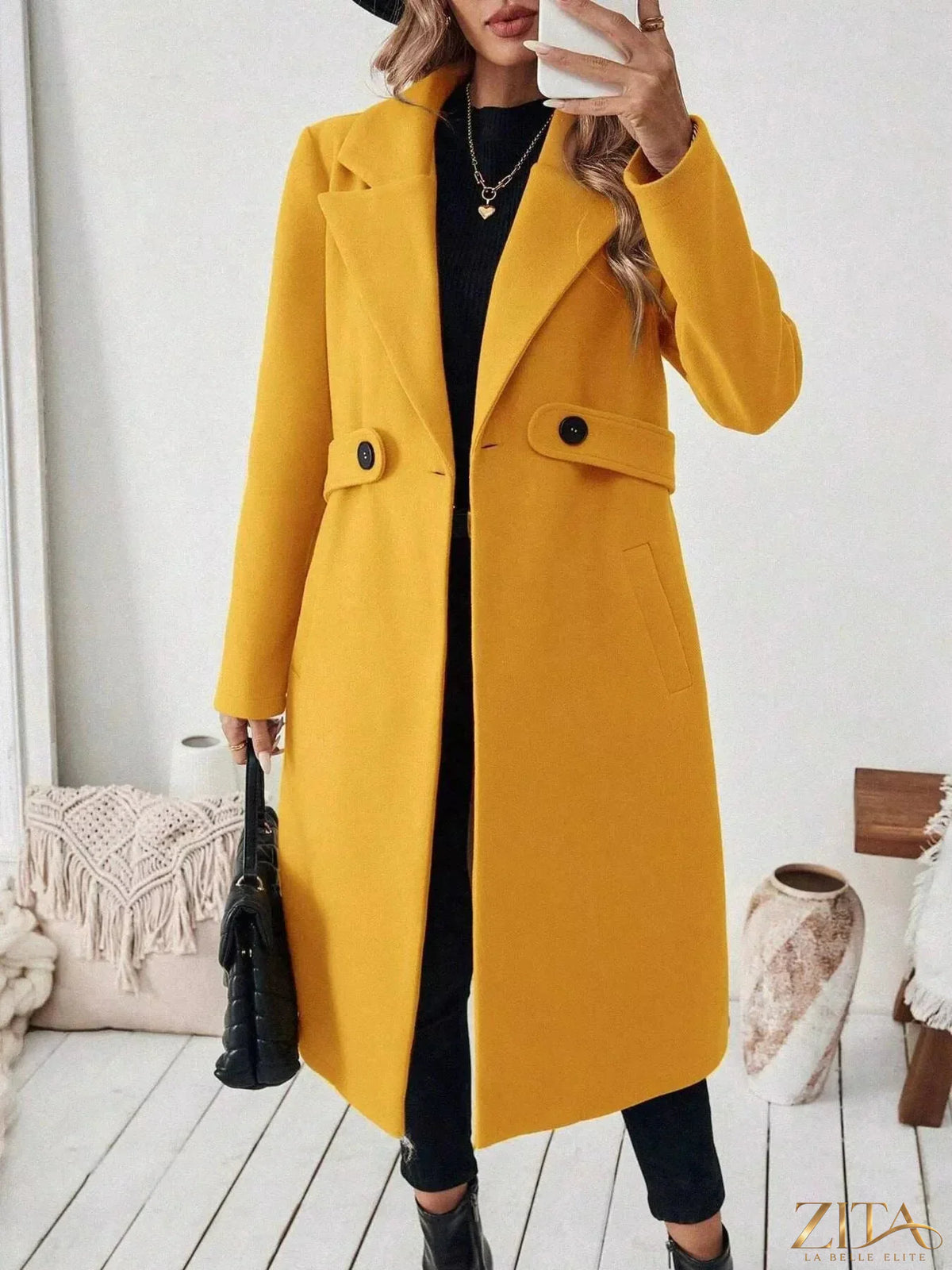 Zita La Belle Elite single-button longline coat in neutral fabric, shown hanging on a hanger with front view.
